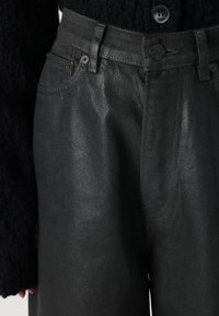 Black denim pants with a straight cut, featuring a textured finish, five-pocket design, and a button closure at the waist.