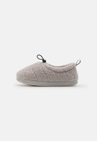 Grey slipper made of textured fabric with a fuzzy surface, rounded shape, elastic drawstring, and a soft, flat sole.