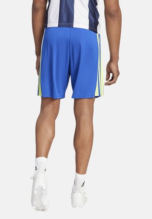 Blue athletic shorts with yellow side stripes, made of lightweight fabric. Displaying a smooth texture and an elastic waistband.