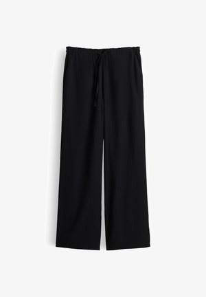 Pantalon noir à jambes larges avec taille élastique et cordon, en tissu texturé, présenté à plat sur fond blanc.