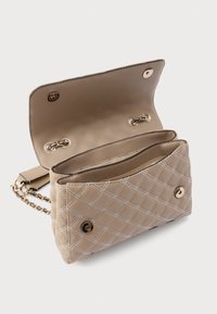 Quilted beige handbag with a smooth leather finish, features gold accents, an adjustable chain strap, and a snap closure. Interior has multiple compartments.