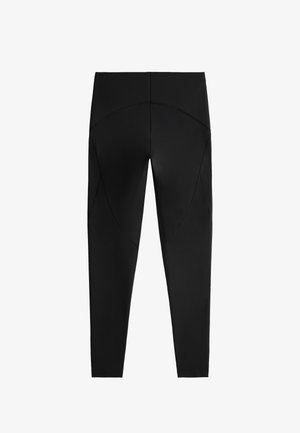 Schwarze Leggings mit glatter Textur, ausgestattet mit abgerundeten Nahtdetails auf der Rückseite, knöchellanger Schnitt und elastischem Bund.