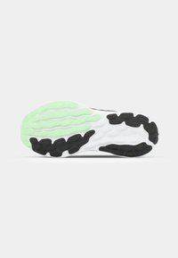 Shoe sole featuring a multi-colored design with green, black, and white sections. Textured rubber for grip with a wave pattern.