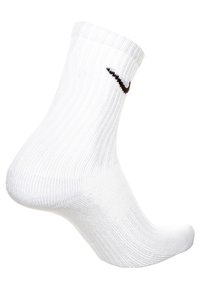 Calzino sportivo bianco con texture a coste, suola imbottita e logo Nike nero sul lato. Design strutturato e lunghezza alla caviglia.