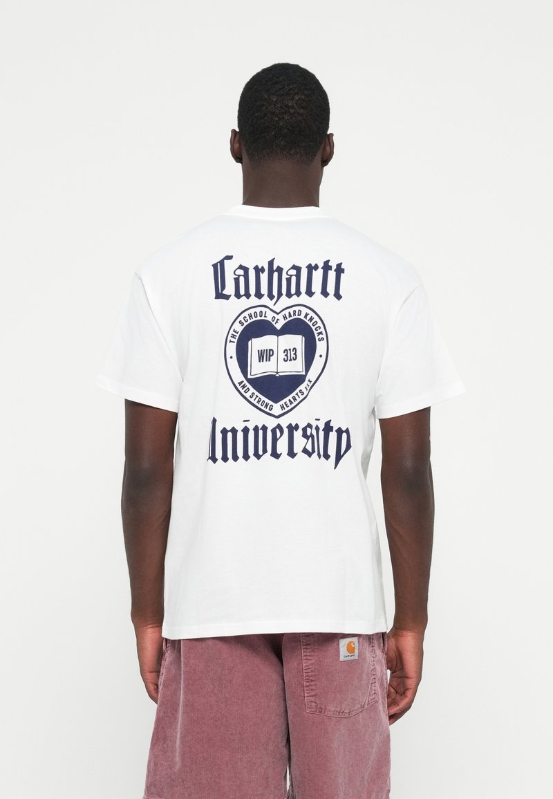 White cotton t-shirt featuring a large navy blue graphic on the back with "Carhartt University" and additional text in a bold font.