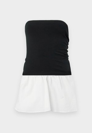 Black strapless top with a gathered texture, transitioning to a flared white cotton skirt. Simple two-tone design, lightweight fabric.