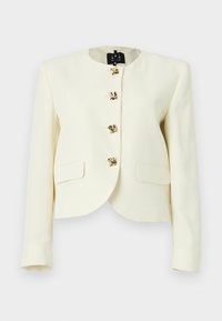 Κοντό μπουφάν σε κρεμ απόχρωση από υφή υφάσματος με στρογγυλή λαιμόκοψη και πέντε κλεισίματα με κουμπιά σε χρυσαφί απόχρωση, με δύο εμπρόσθιες τσέπες.