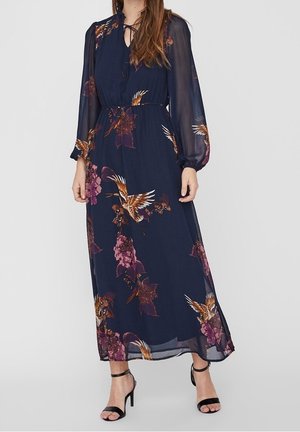 Marineblaues Maxikleid mit Blumenmuster und transparenten langen Ärmeln, verziert mit violetten Blumen und Vögeln. Mit einer Krawattenhose am Ausschnitt und einem taillierten Gürtel.