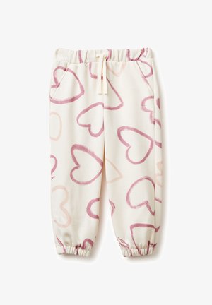 Pyjamabroek van zachte stof, met een crèmekleurige achtergrond en roze hartpatronen, elastische tailleband en geplooide manchetten.