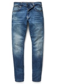 Jean slim bleu avec des zones décolorées aux cuisses et genoux, doté de poches avant, passants pour ceinture et braguette partiellement déboutonnée.