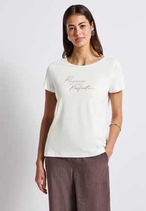 White short-sleeve t-shirt made of soft fabric, featuring a "Progress over Perfection" print in a contrasting beige font at the center.
