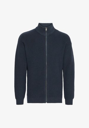 Granatowy sweter na zamek błyskawiczny z prążkowaną teksturą, wysokim kołnierzem i dwoma bocznymi kieszeniami. Posiada zamek błyskawiczny na całej długości oraz dopasowane mankiety.