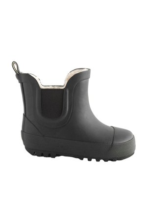 Botte de pluie noire à cheville avec semelle texturée, panneau latéral élastique, languette de traction au talon et doublure en polaire blanche visible en haut.