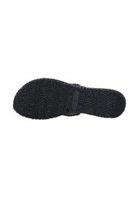 Suola di scarpa in gomma nera con modello di presa testurizzato, caratterizzata da loghi in rilievo e piccoli fori circolari per trazione e flessibilità.