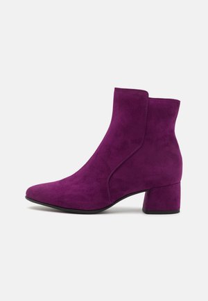Fuchsia suede ankle boots with a pointed toe and block heel. Features smooth texture and seam detailing along the side panels.