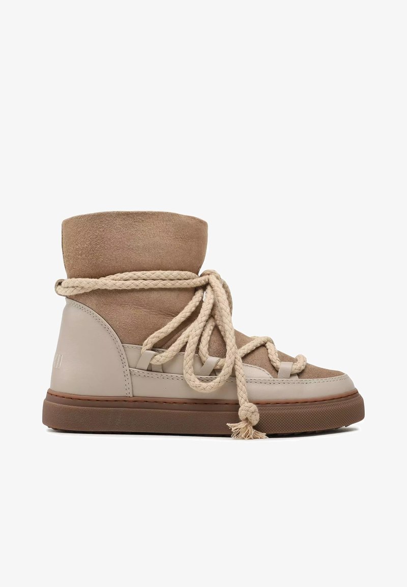 Stivaletti alla caviglia in suede e pelle beige con punta rotonda, caratterizzati da una tomaia testurizzata, spesse stringhe di corda intrecciata e suola in gomma.