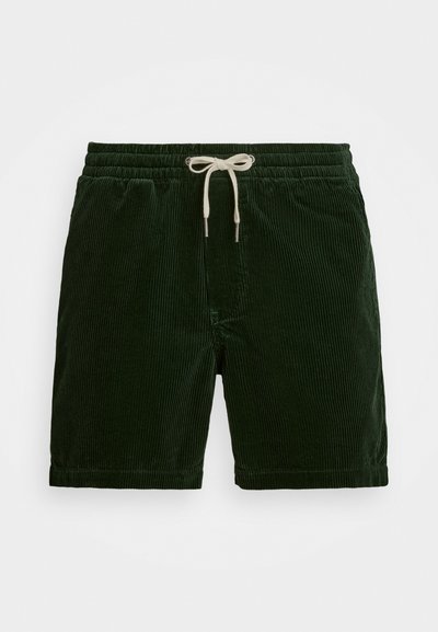 Calções de veludo cotelê verdes com uma cintura elástica e um cordão branco. Textura com riscas verticais, comprimento até à coxa e sem bolsos visíveis.