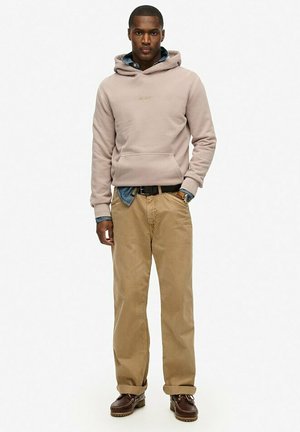 Light beige hoodie with front pocket, layered over a denim shirt. Paired with khaki pants and brown boots. Simple, casual design.