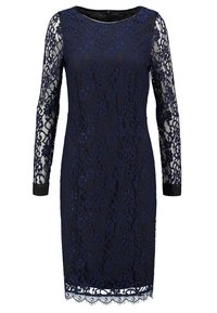 Robe en dentelle bleu marine avec de longues manches transparentes, ourlet festonné, encolure unie et silhouette ajustée. Le motif en dentelle présente des motifs floraux.