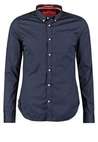 Námornická košile s dlouhým rukávem na knoflíky, bavlněný materiál, klasický límeček, jedna náprsní kapsa a kontrastní akcent vnitřního límečku.