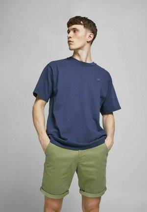 Navy blue cotton t-shirt with a relaxed fit, paired with light green rolled shorts. Simple design with no visible patterns or accents.