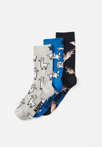 Three pairs of cotton socks: gray with llama print, blue with dog design, and black with different animal graphics. Each pair has contrasting colors.