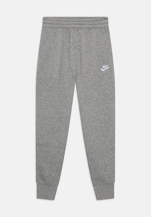 Pantalon de survêtement gris Nike avec taille et chevilles élastiques, arborant un logo blanc Nike sur la partie supérieure de la cuisse gauche.