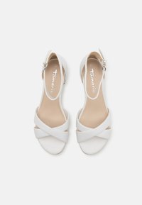 White open-toe sandals with cross-strap design, adjustable ankle buckle, smooth faux leather upper, and beige insole. Size 37.