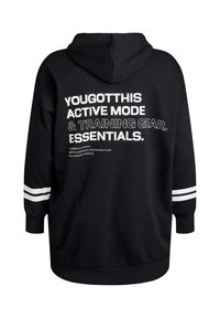 Melna kapuce ar lielu baltu tekstu uz muguras, kurā rakstīts "TU TO VARI" un svītras uz piedurknēm. Izgatavots no mīksta auduma.