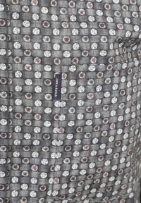 Gray patterned fabric featuring small white and colored circular designs. Tag sewn into seam with "State of Art" branding.