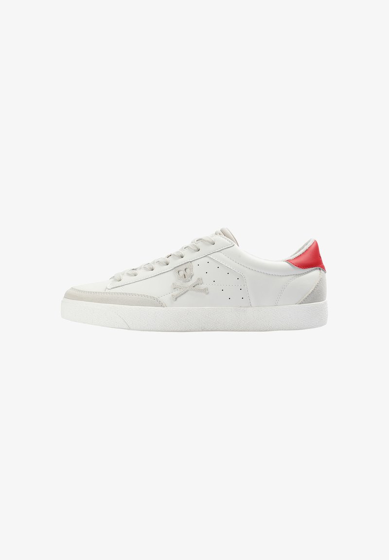 White low-top sneaker with light gray suede accents, a red heel tab, skull and crossbones logo on the side, and white rubber sole.