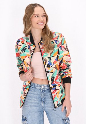 Giacca bomber colorata con un motivo di foglie astratte nei toni del verde, rosso e giallo, con polsini a coste e chiusura con zip.