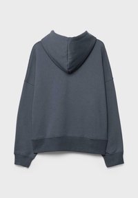 Sweat à capuche oversize gris foncé vu de dos avec manches longues, poignets côtelés et une capuche.