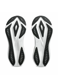 Witte sportieve schoenzolen met een gestructureerd zwart rubberen patroon, voorzien van groeven en een ruitvormig ontwerp voor grip.
