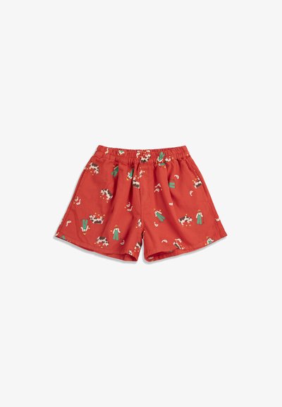 Pantaloncini rossi con vita elasticizzata, decorati con stampe di mucche, contadini e cosce di pollo.