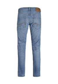 Blugi din denim albastru deschis, cu croi slim, având două buzunare la spate și cusături distinctive într-un model ondulat. Patch din piele sintetică pe talie.