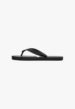 Sandale tongs en caoutchouc noir avec semelle texturée et bride en forme de Y sur fond blanc.
