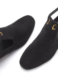 Črne antilop čevlje do gležnjev z odprtim stranskim delom in zlatim okrasom. Oblika z ostrim nosom. Mehak material, eleganten in minimalističen slog.