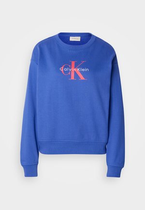 Blauer Baumwollpullover mit Rundhalsausschnitt, langen Ärmeln und einem aufgedruckten Logo in Weiß und Rot auf der Vorderseite. Weicher Stoff mit gerippten Bündchen.