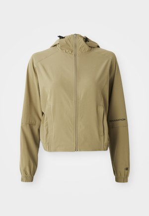 Lys brun hettejakke med glidelås, elastiske ermer, side-lommer og "Champion"-logo på venstre erme.