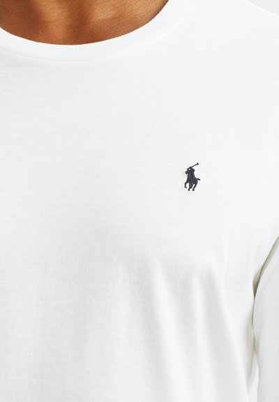 White cotton T-shirt with a round neckline and short sleeves. Features a small black logo of a rearing horse on the left chest.