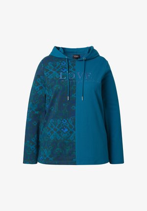 Teal huppari, jossa on jaettu muotoilu: toisella puolella on monimutkaisia kuvioita, toisella puolella yksivärinen. Teksti "Rakkaus voittaa aina" brodeerattu vastavärillä.