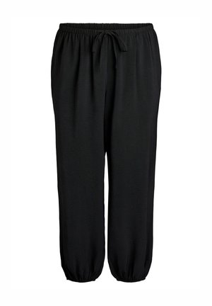 Čierne nohavice s elastickým pásom so šnúrkou a elastickými manžetami na členkoch, voľný strih, vhodné na bežné nosenie.