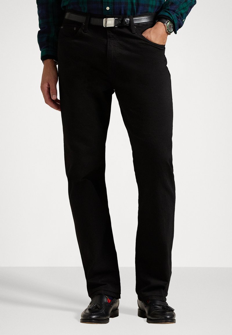 Black denim trousers with a straight leg design, featuring front pockets, a belt loop, and a textured finish. Worn with black shoes.