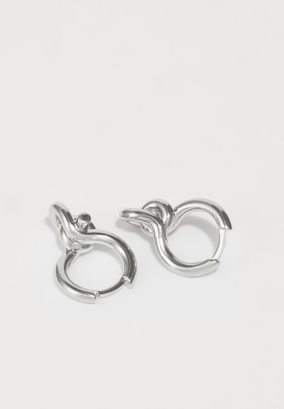 Silver hoop earrings featuring a twisted design and smooth finish. The earrings have a secure clasp mechanism and a shiny appearance.