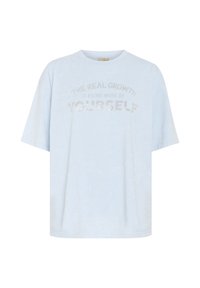 T-shirt oversized bleu clair en coton doux. Présente un design texturé et un texte en paillettes argentées : "LA VRAIE CROISSANCE EST D'ÊTRE DAVANTAGE SOI-MÊME."
