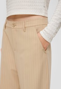 Tijger gestreepte broek van soepel materiaal, met zijzakken, een knoopsluiting en een subtiele logotag op de zak.