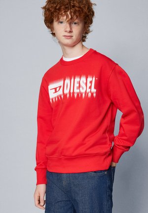 Felpa rossa in cotone, con un logo "DIESEL" bianco e consumato sul davanti. Maniche e orlo a costine, con scollatura rotonda.