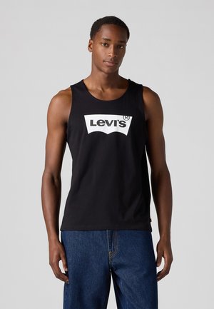 Black tank top made of cotton, featuring a white Levi's logo across the chest. No sleeves, round neckline, and a relaxed fit.