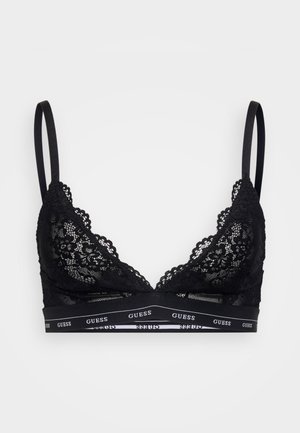Zwarte kant bralette met driehoekige cups, verstelbare bandjes en een elastische band met witte "GUESS" logo accenten aan de onderkant.